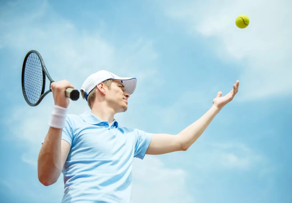 tennis player playing hardcourt serving ball