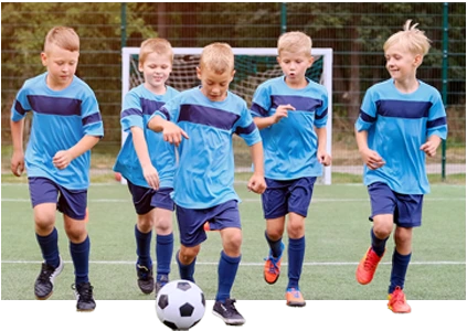 five blue shirt kids running with the ball