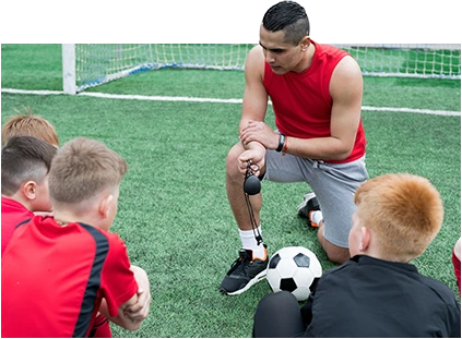 coach teaching the kids how to play football