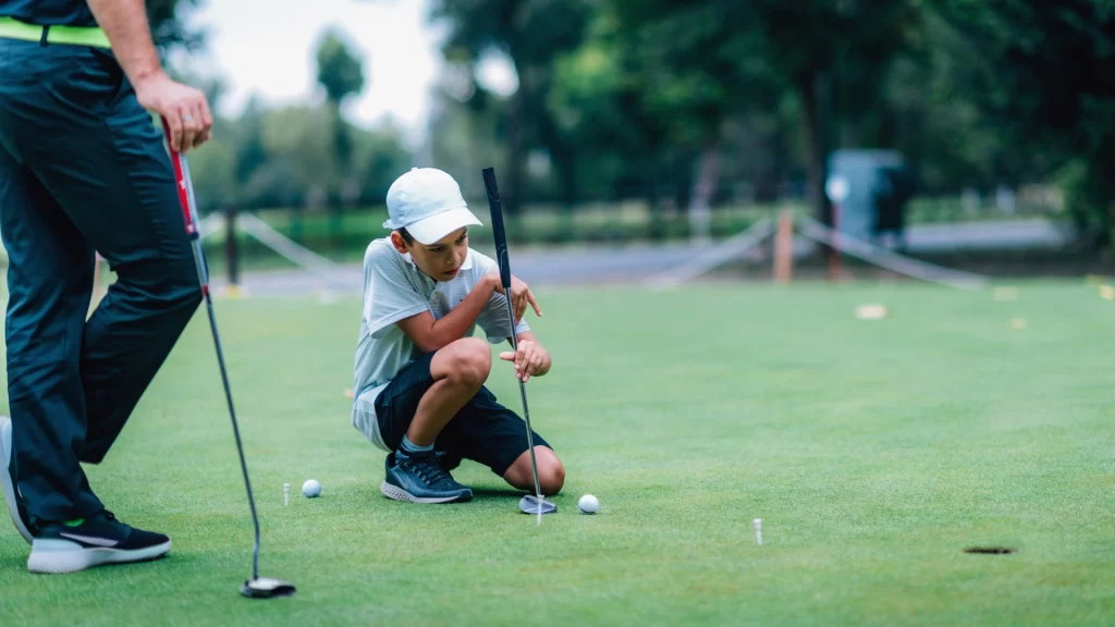 kid playing with ball on grassland